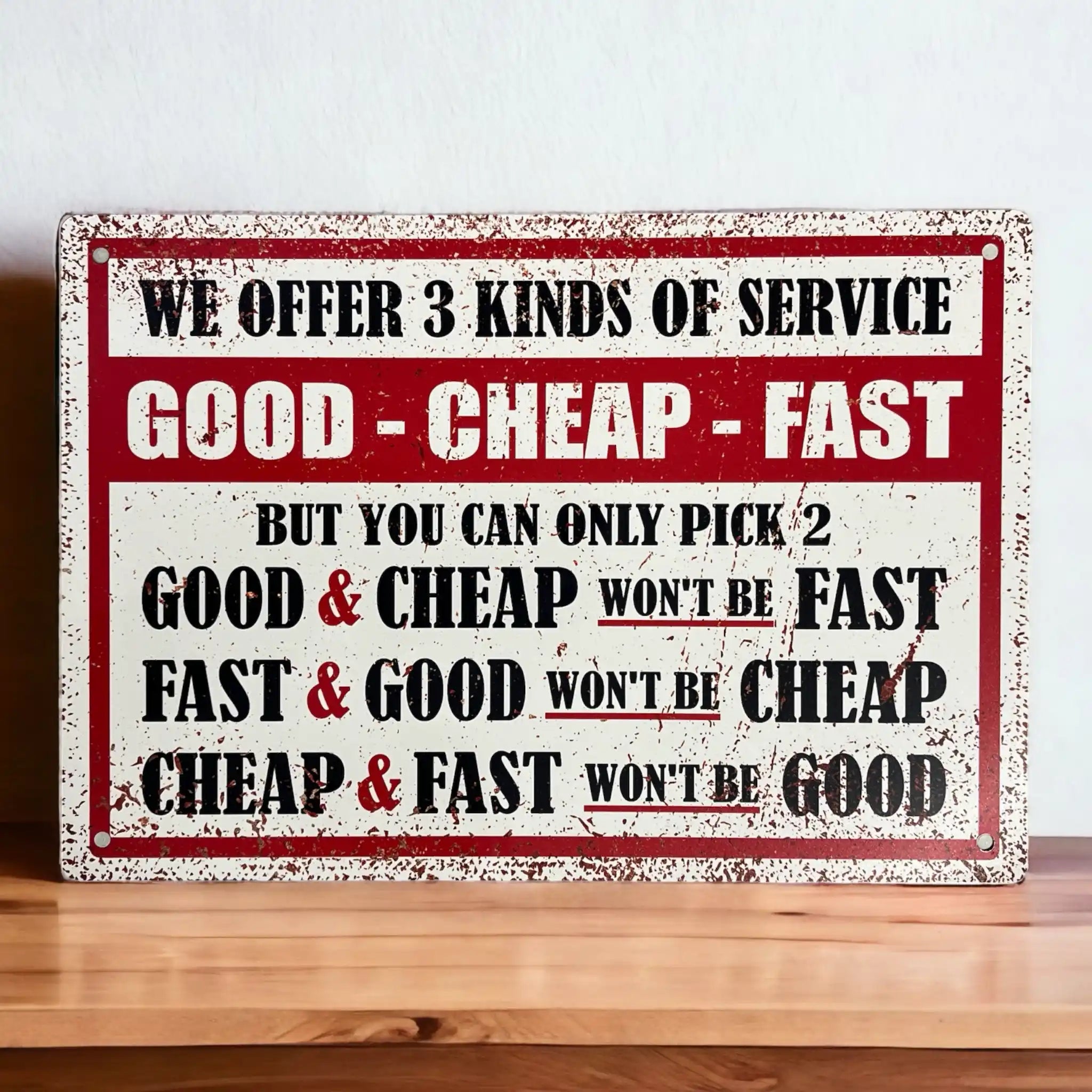 A vintage-style aluminium novelty sign with a distressed look, featuring the humorous business maxim 'We offer 3 kinds of service: Good - Cheap - Fast, but you can only pick 2.' from Laser Design Creations