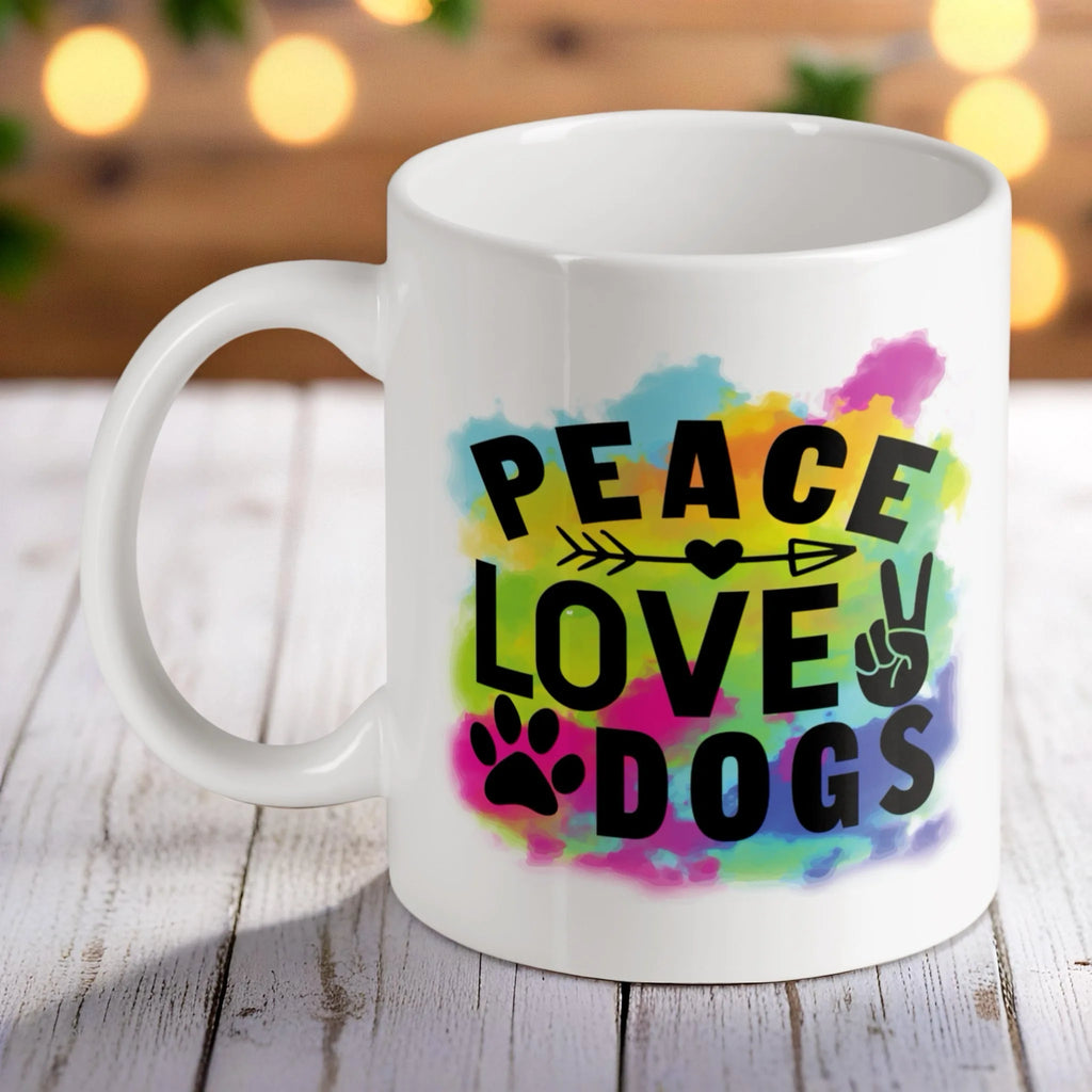 Peace Love Dogs hippie-style ceramic mug by Laser Design Creations, featuring bold black text over a vibrant watercolour splash background.