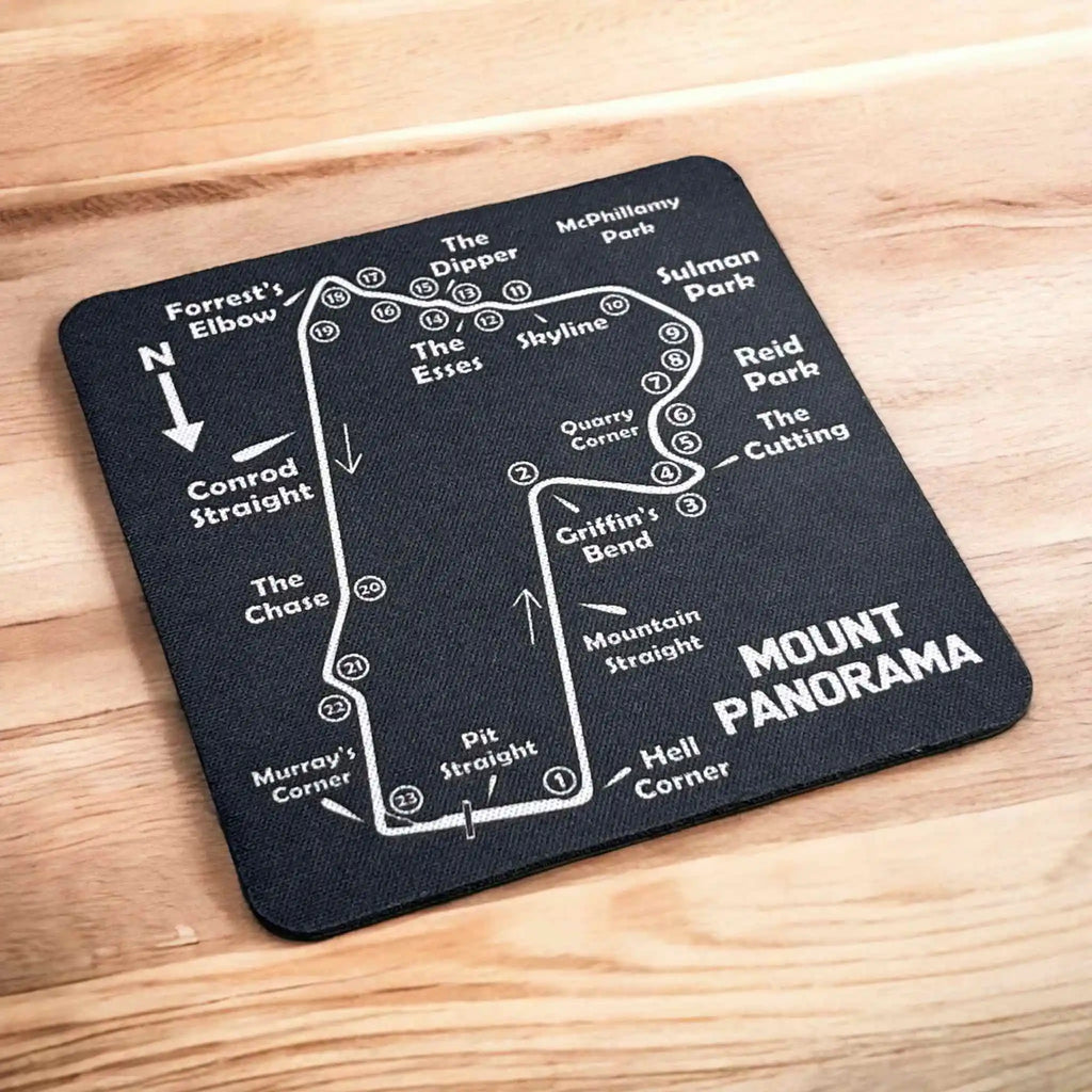 Side view of a stack of four Bathurst Mount Panorama map neoprene coasters, highlighting the non-slip backing, by Laser Design Creations.