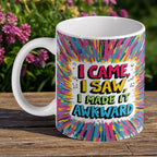 "I Made It Awkward" Quote ceramic mug by Laser Design Creations, featuring the quote "I Came, I Saw, I Made It Awkward" in a vibrant, funky comic-book style.