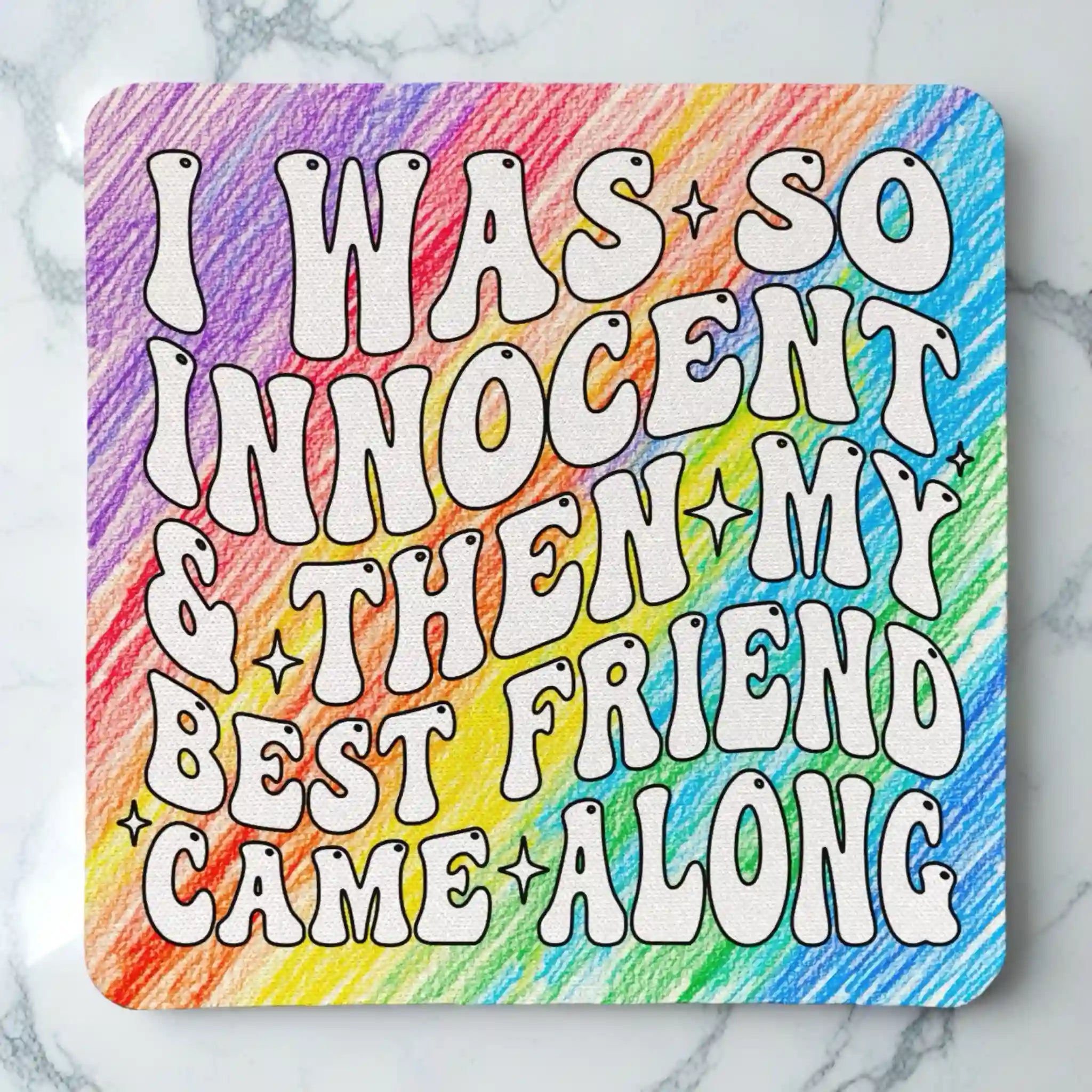 Top view of I Was So Innocent neoprene coaster with colourful retro rainbow pencil textured friendship quote, by Laser Design Creations.