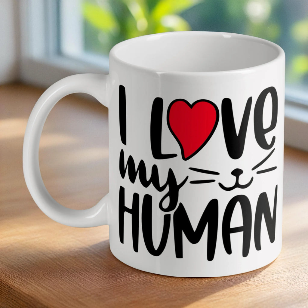 'I Love My Human' cat-themed ceramic mug by Laser Design Creations, featuring bold black text and a red heart on a white background.