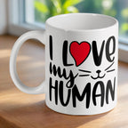 'I Love My Human' cat-themed ceramic mug by Laser Design Creations, featuring bold black text and a red heart on a white background.