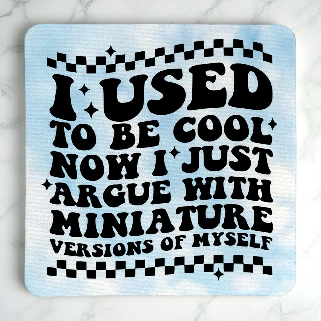 Top view of I Used To Be Cool neoprene coaster with retro wavy text and blue cloud background, by Laser Design Creations.