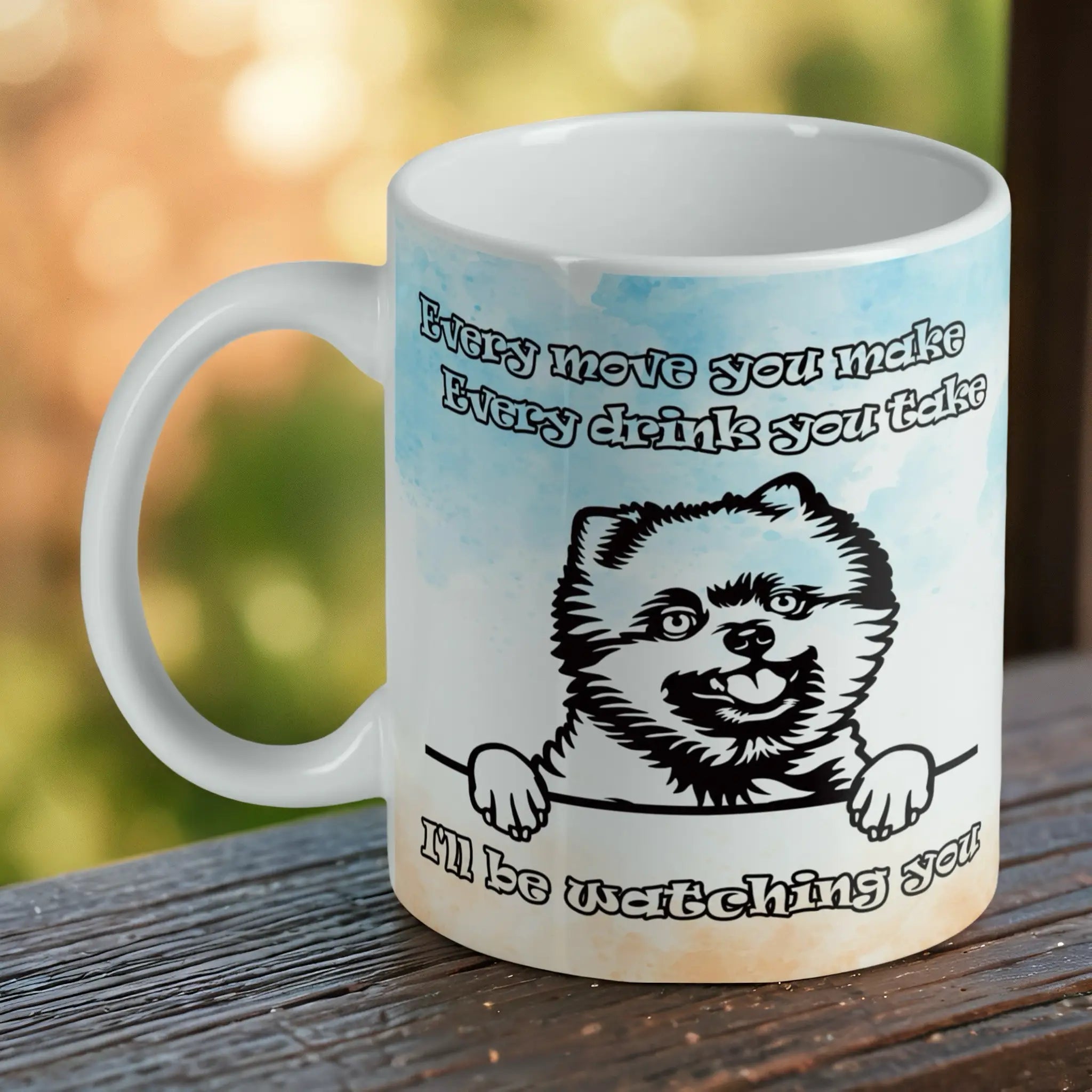 Funny Peeking Pomeranian ceramic mug by Laser Design Creations, featuring a humorous watercolour Pomeranian with the quote 'I'll be watching you' on a white background.
