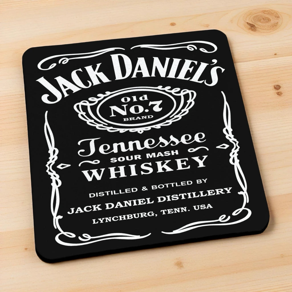 Side view of Jack Daniel's Old No. 7 neoprene coasters, showcasing classic vintage label styling on a dark wood bar top by Laser Design Creations.