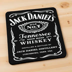 Side view of Jack Daniel's Old No. 7 neoprene coasters, showcasing classic vintage label styling on a dark wood bar top by Laser Design Creations.