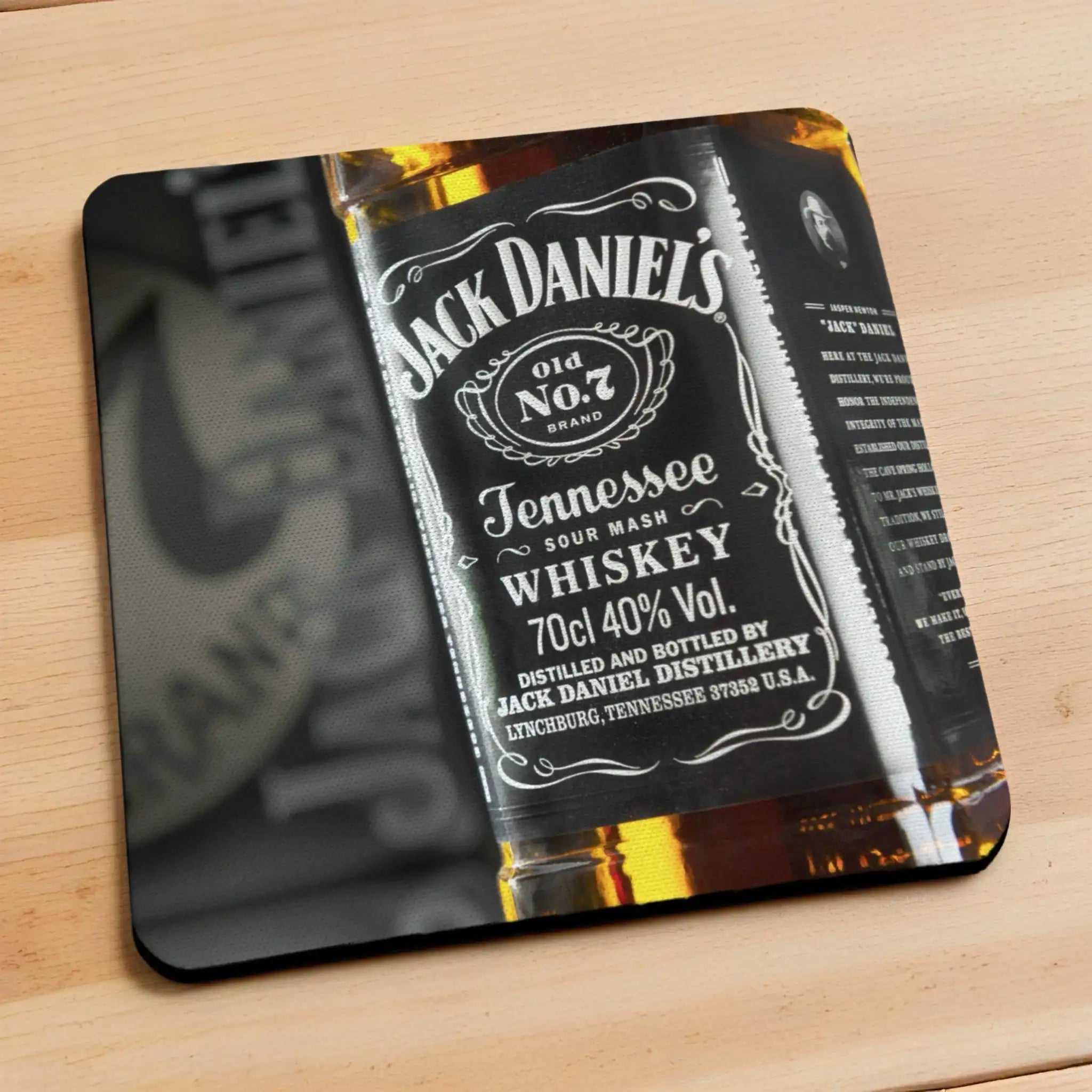 Side view of Jack Daniels Whiskey neoprene coasters, showcasing a vintage, rustic Jack Daniel's Tennessee Whiskey label design set against a dark home bar backdrop by Laser Design Creations.