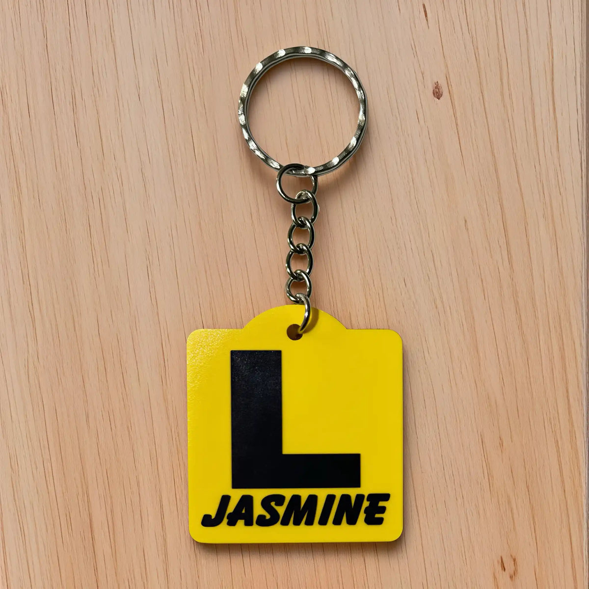 Front view of Personalised Learner L Plate acrylic keyring, showcasing an iconic Australian driving plate design with custom name against a soft neutral background by Laser Design Creations.