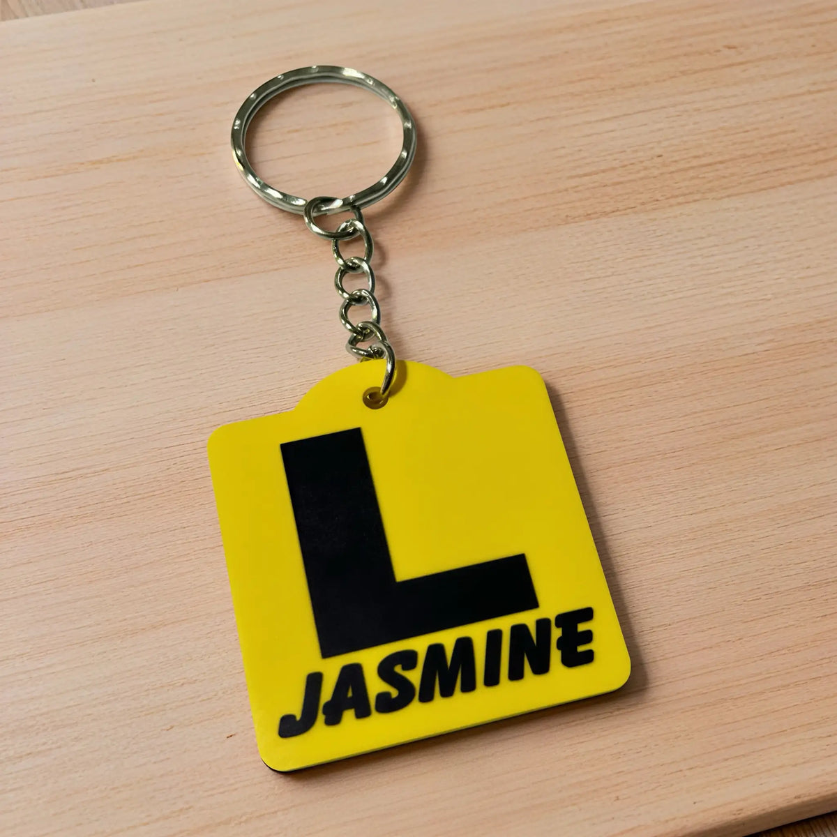 Side view of Personalised Learner L Plate acrylic keyring, showcasing an iconic Australian driving plate design with custom name against a soft neutral background by Laser Design Creations.