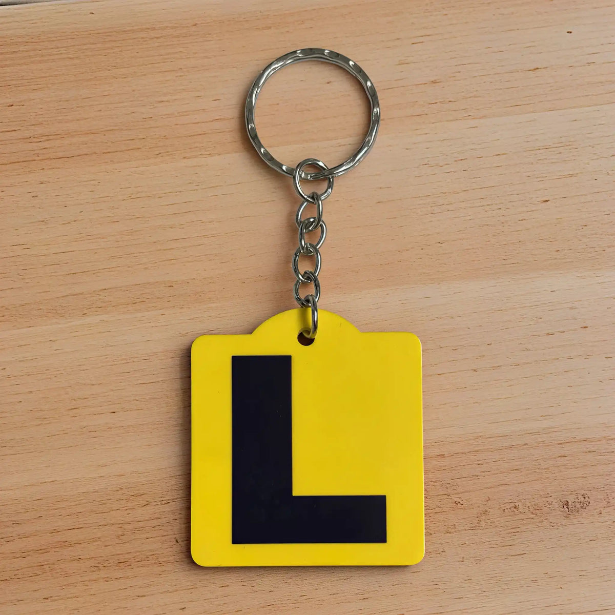 Front view of Learner L Plate acrylic keyring, showcasing an iconic Australian driving plate design against a soft neutral background by Laser Design Creations.