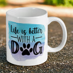 Reverse side of Life is better with a dog quote and watercolour paw print ceramic mug, showcasing the quote 'Life is better with a dog' in modern typography next to a colourful watercolour paw print on a white background by Laser Design Creations.