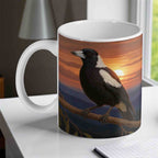 Majestic Australian Magpie at Sunset ceramic mug by Laser Design Creations, with a scenic mountain background.