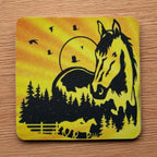 Top view of a set of four Horse Silhouette neoprene coasters with a vibrant sunset and nature scene, by Laser Design Creations.