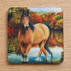 Top view of a set of four Wild Mustang neoprene coasters with a serene river and autumn colours, by Laser Design Creations.