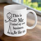 Reverse side of the 'Mind Your Own Business' stick figure mug, showcasing the wrap-around artwork by Laser Design Creations.