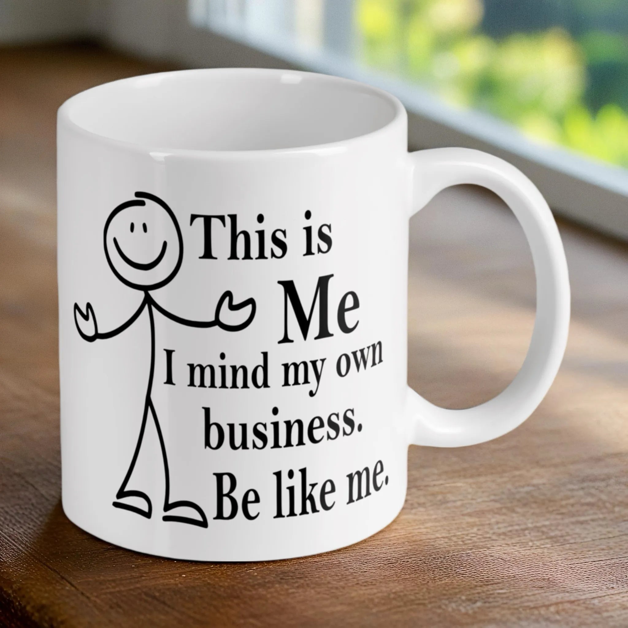 Reverse side of the 'Mind Your Own Business' stick figure mug, showcasing the wrap-around artwork by Laser Design Creations.