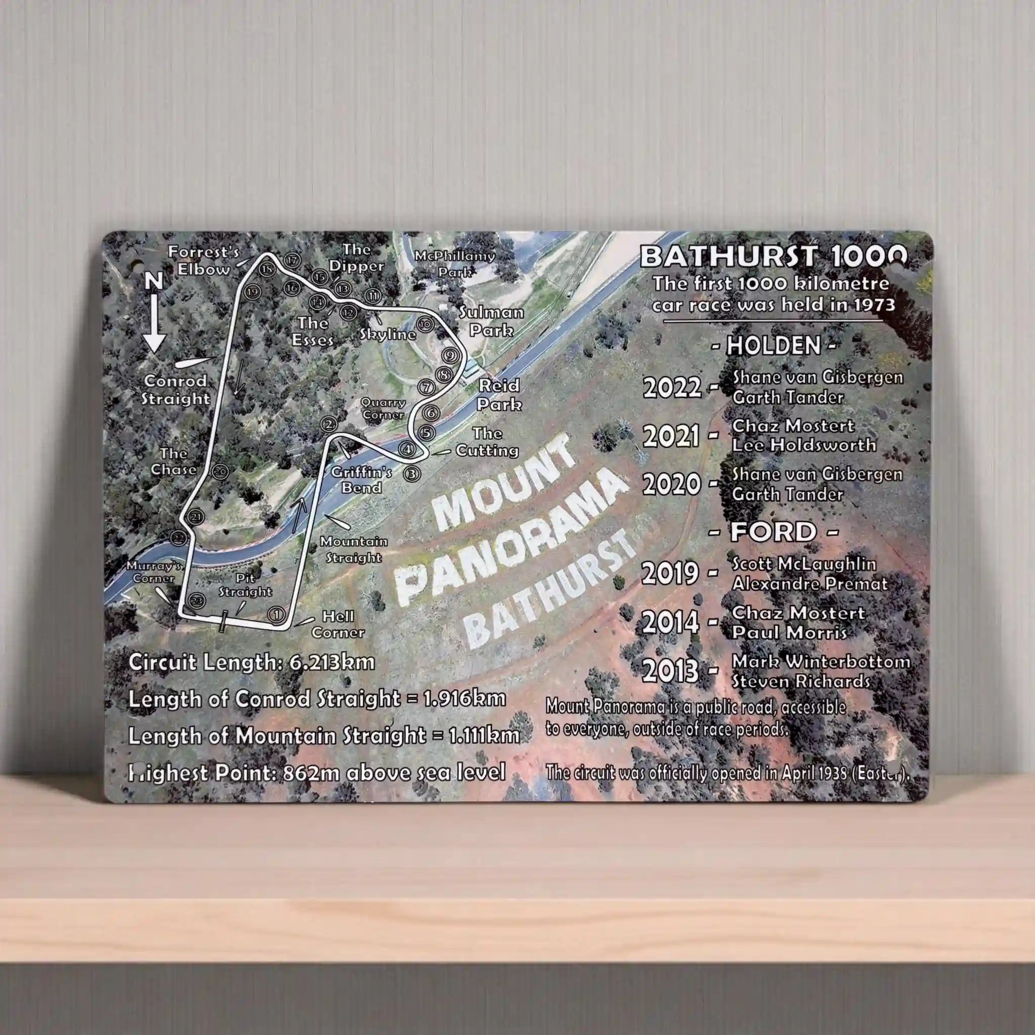 An informational aluminium sign showing the Mount Panorama race track map and a list of Bathurst 1000 winners from Laser Design Creations