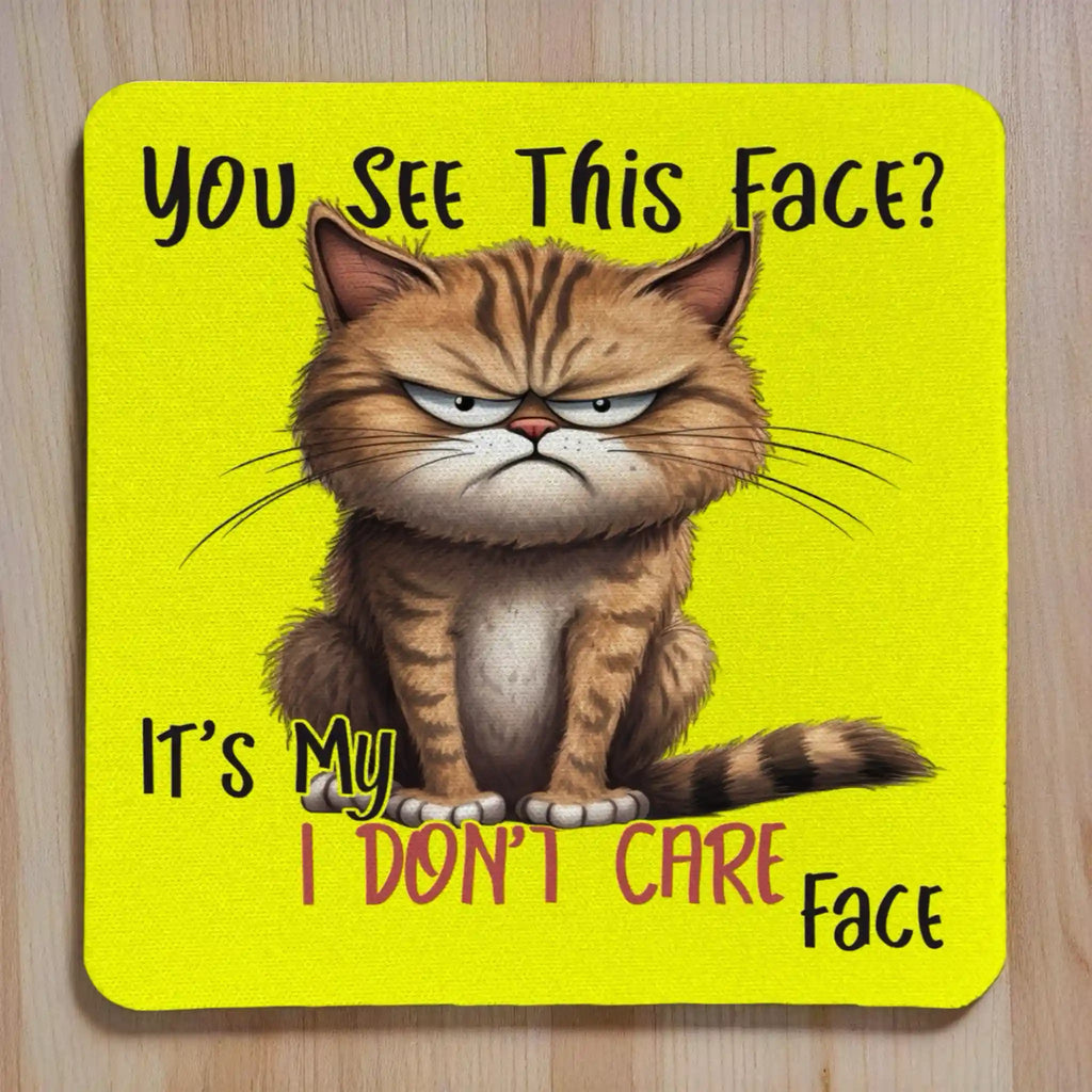 My I Don't Care Face Grumpy Yellow Cat neoprene coasters by Laser Design Creations, featuring a funny yellow grumpy cat cartoon and the sassy quote, You See This Face? It's My I DON'T CARE Face.