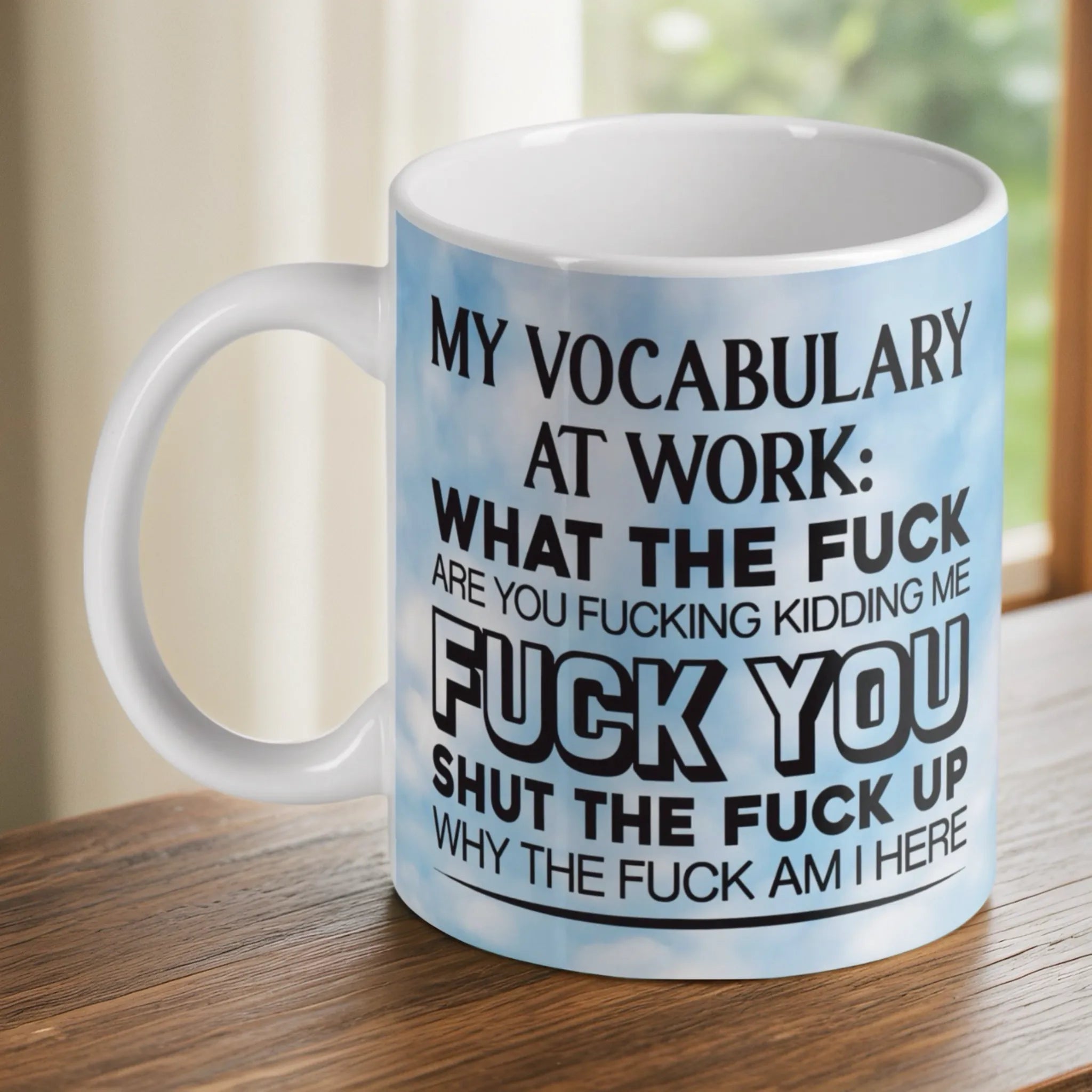 My Vocabulary At Work Sweary ceramic mug by Laser Design Creations, featuring funny office swearing quotes in bold text against a blue sky with white clouds background.