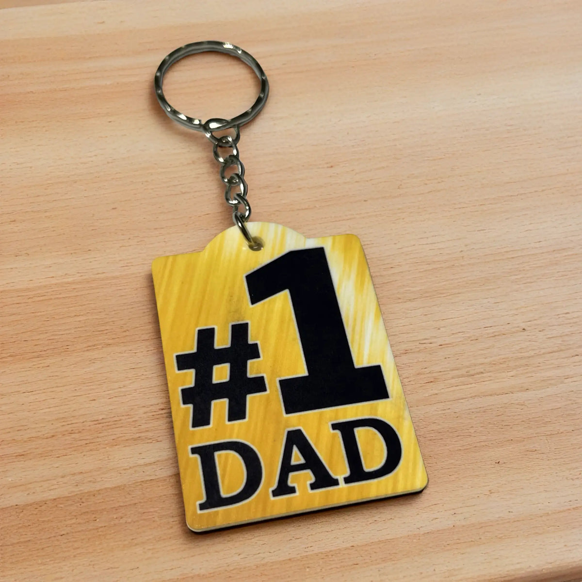 Side view of Number 1 Dad acrylic keyring, showcasing the bold golden textured number one design for parents by Laser Design Creations.