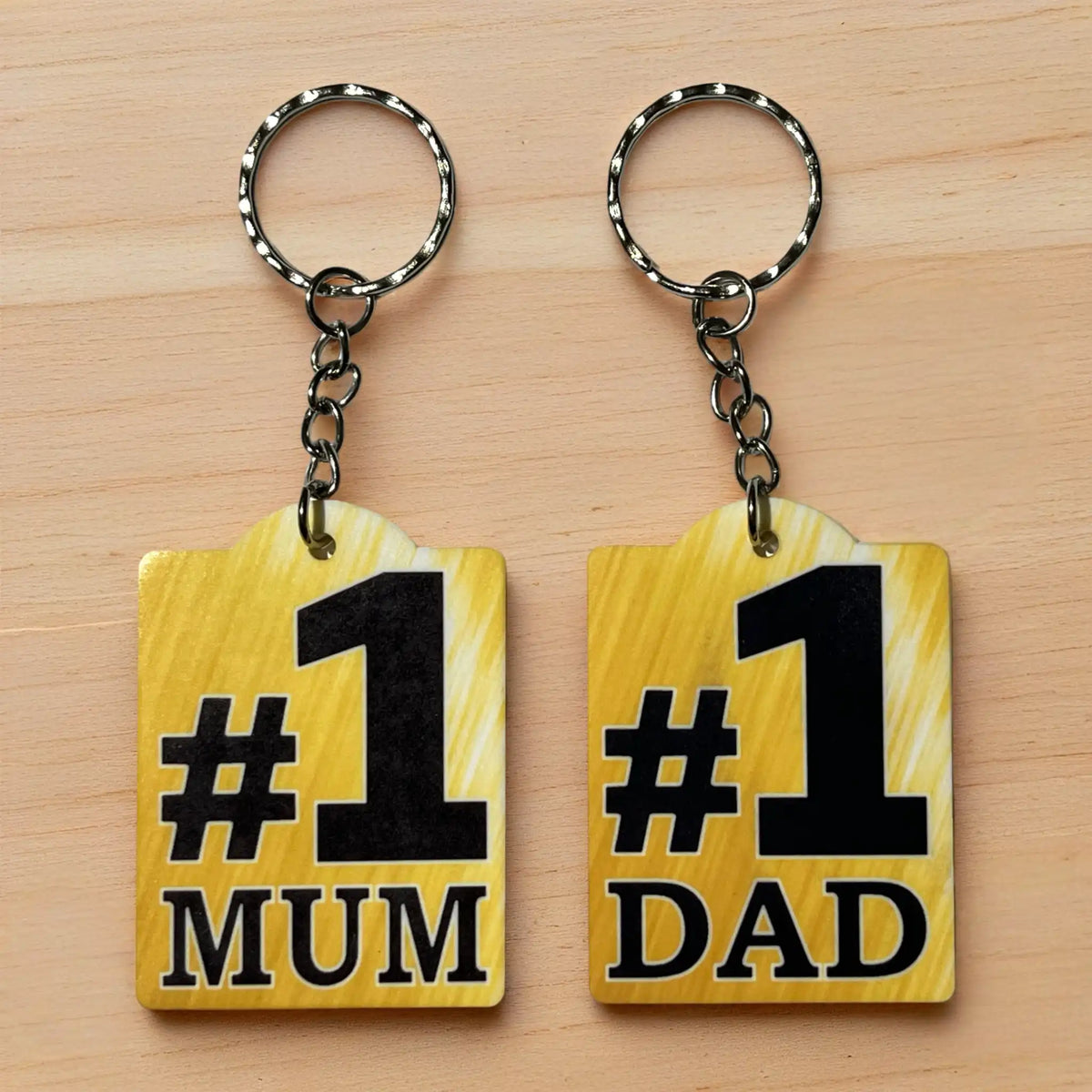 Collage image of the Number 1 Mum & Dad acrylic keyrings, printed by Australian small business Laser Design Creations.