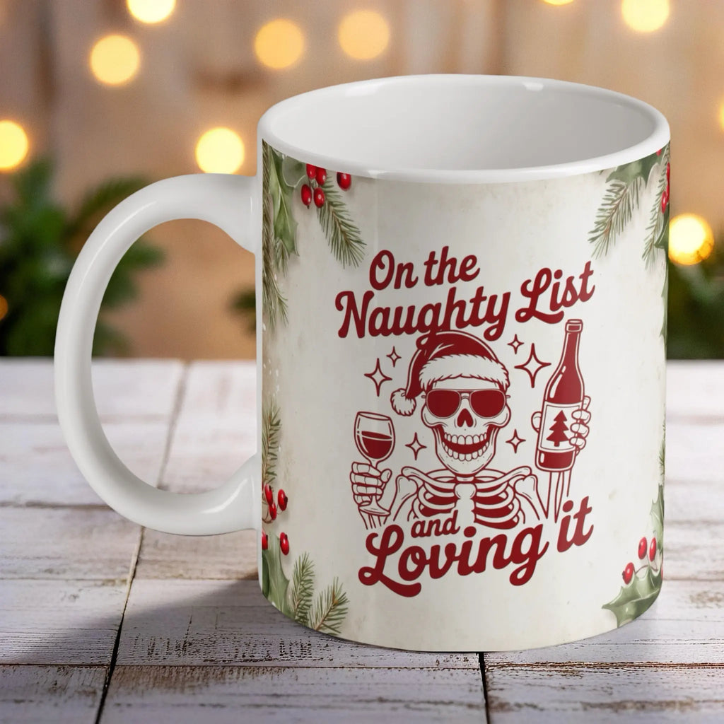"On the Naughty List and Loving it" Mug - Festive Skull Wine Lover ceramic mug by Laser Design Creations, featuring a humorous vintage skeleton holding a wine glass with "On the Naughty List and Loving it" text, perfect for Christmas.