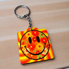 Psychedelic Floral Smiley Face keyring, showcasing a vibrant yellow smiley face and groovy floral patterns by Laser Design Creations.