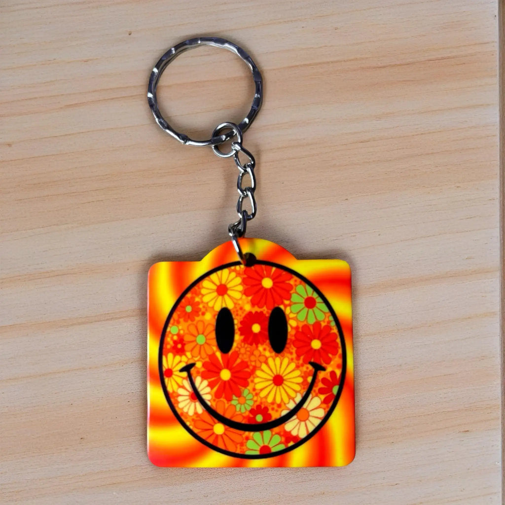 Psychedelic Floral Smiley Face keyring by Laser Design Creations, featuring a fun, retro smiley face graphic surrounded by swirling psychedelic flowers.