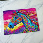 Vibrant Floral Horse Sunset chopping board by Laser Design Creations, featuring a psychedelic horse silhouette filled with bohemian flowers set against a colourful sunset. Displayed on a marble countertop.