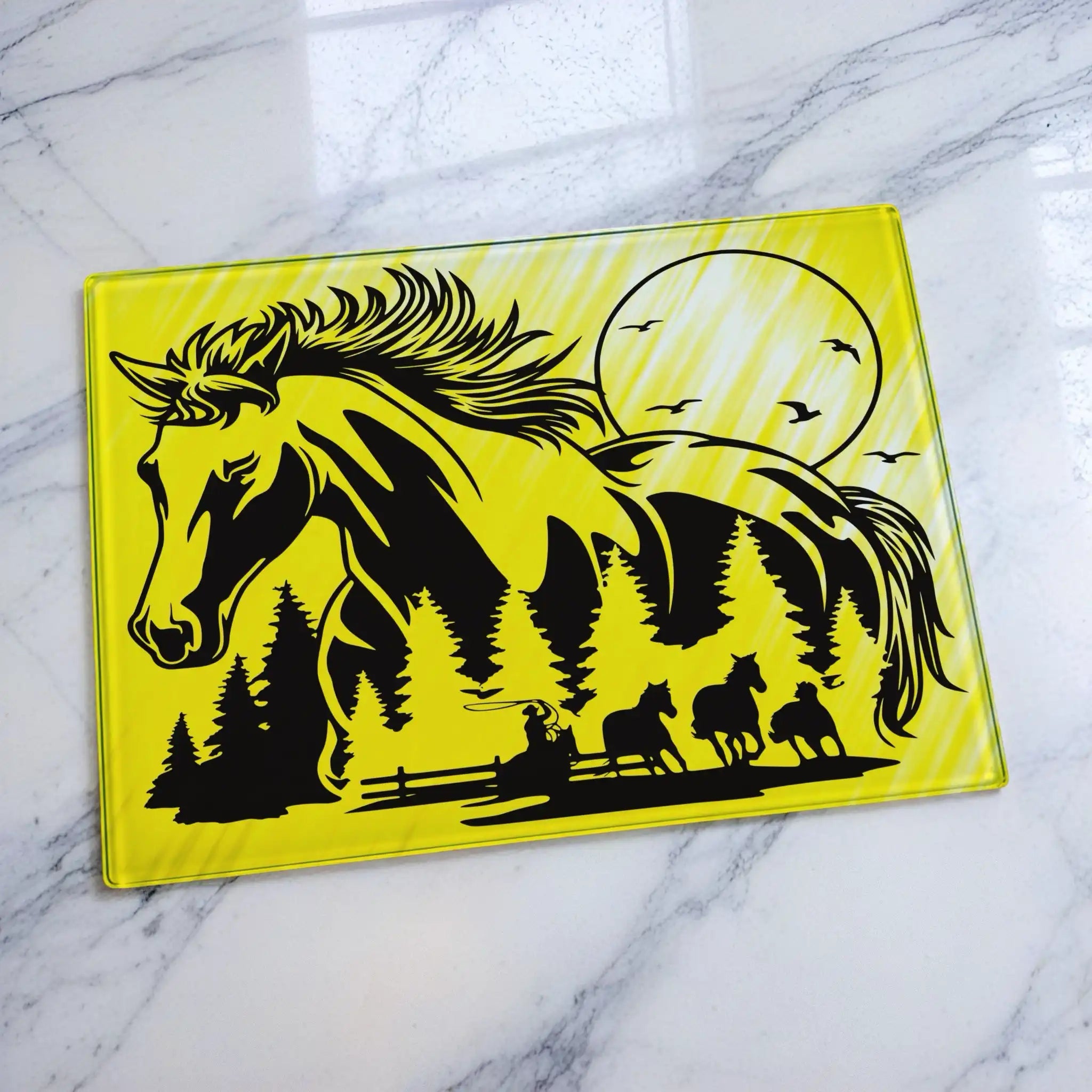 Chopping board by Laser Design Creations, featuring a double exposure design of a horse's profile filled with a cowboy and ranch landscape. Displayed on a marble countertop.