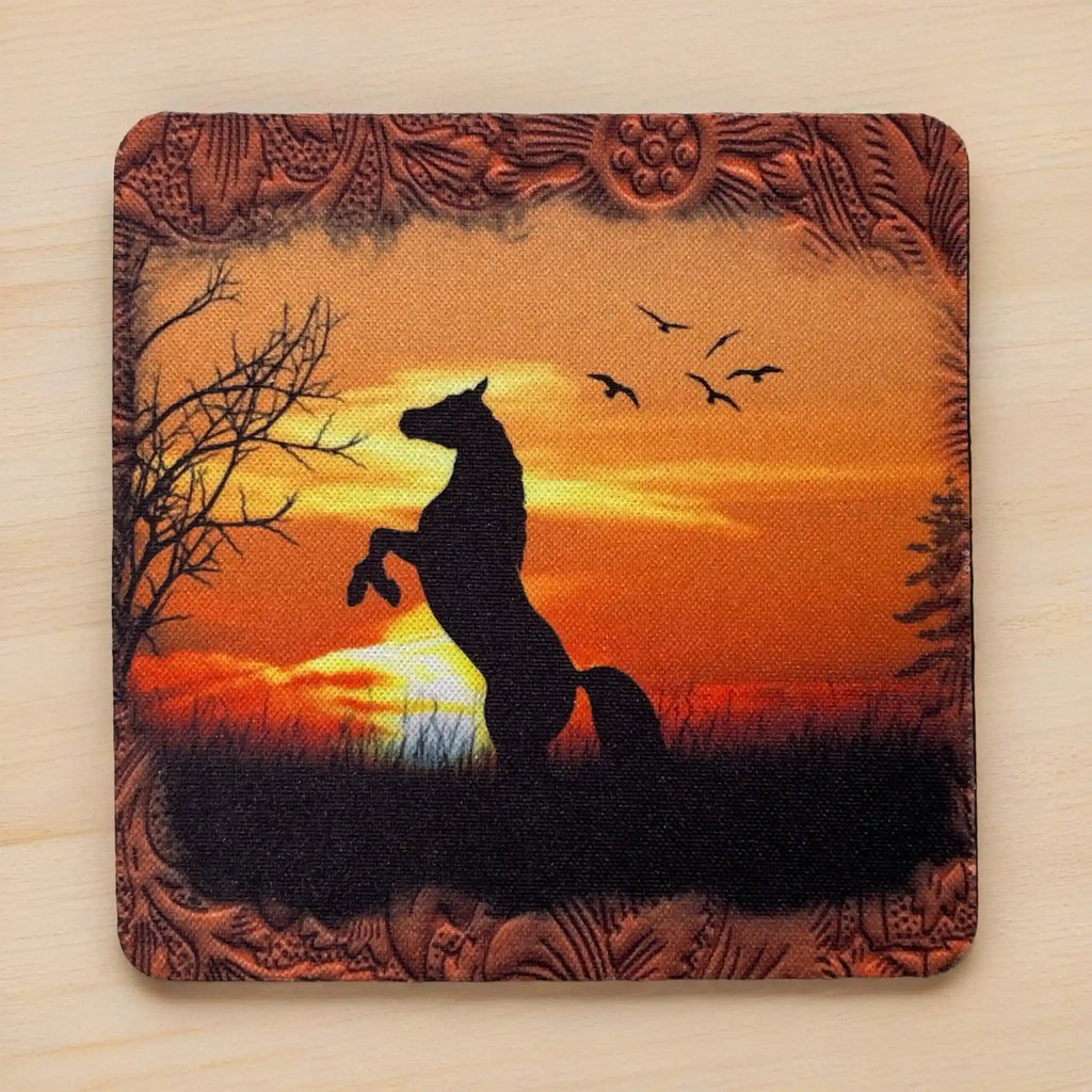 Top view of a set of four Rearing Horse Sunset neoprene coasters with a fiery sunset and wild horse, by Laser Design Creations.