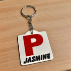 Side view of Personalised Red P Provisional Plate acrylic keyring, showcasing an iconic Australian driving plate design with custom name against a soft neutral background by Laser Design Creations.