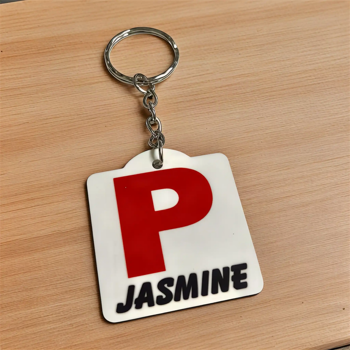 Side view of Personalised Red P Provisional Plate acrylic keyring, showcasing an iconic Australian driving plate design with custom name against a soft neutral background by Laser Design Creations.