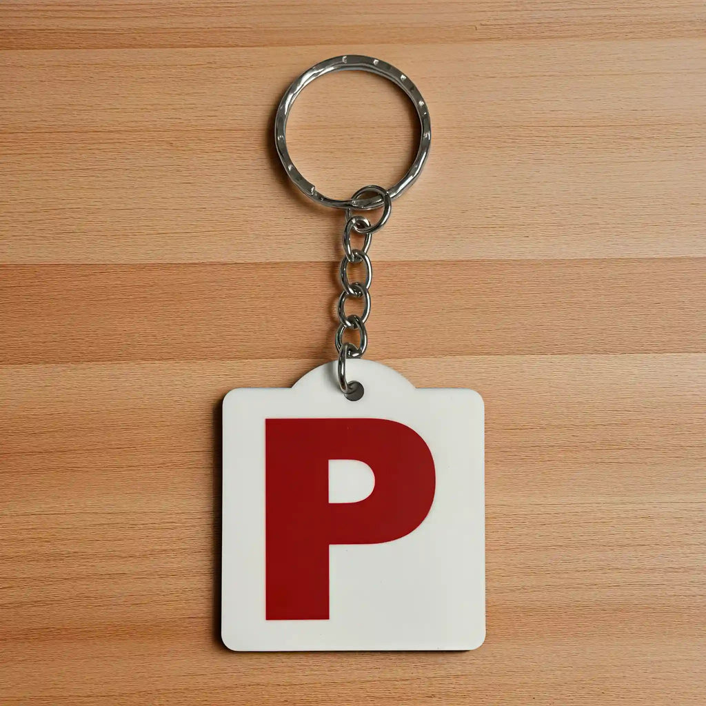Front view of a Red P Provisional Plate acrylic keyring, showcasing an iconic Australian driving plate design against a soft neutral background by Laser Design Creations.