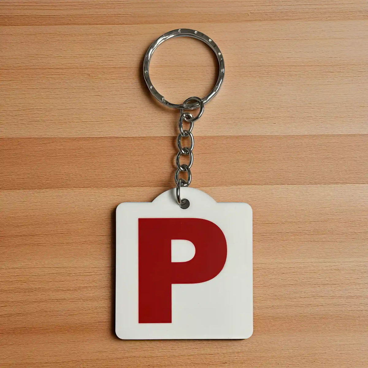 Front view of a Red P Provisional Plate acrylic keyring, showcasing an iconic Australian driving plate design against a soft neutral background by Laser Design Creations.