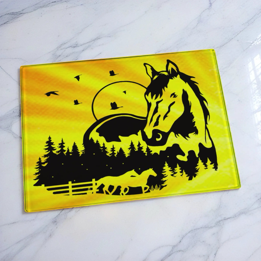 Double exposure running horses sunset forest country art glass chopping board from Laser Design Creations featuring beautiful silhouettes of majestic horses in a warm country landscape.
