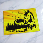 Double exposure running horses sunset forest country art glass chopping board from Laser Design Creations featuring beautiful silhouettes of majestic horses in a warm country landscape.