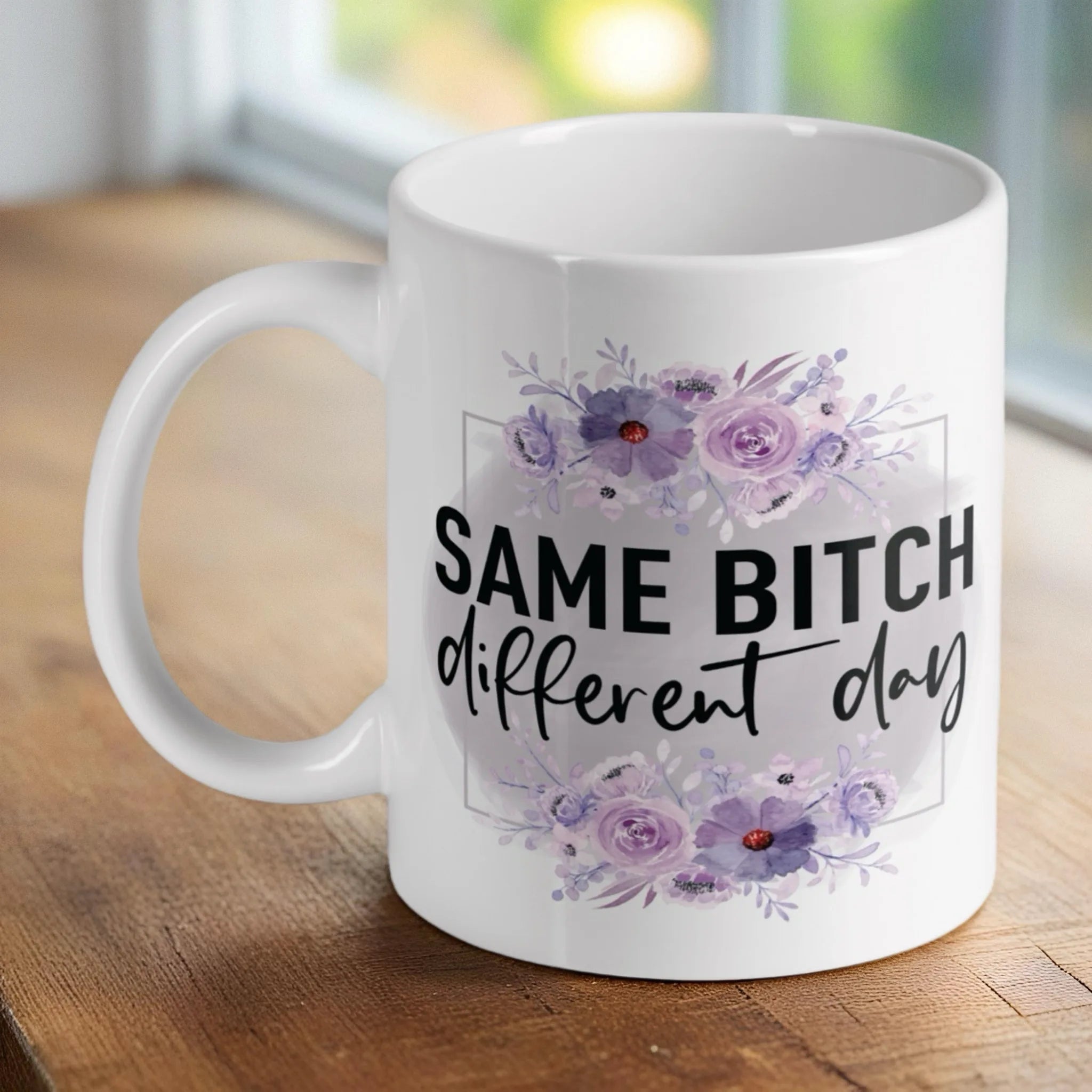 Floral 'Same Bitch Different Day' ceramic mug by Laser Design Creations, featuring a sassy quote with a purple floral design.