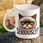 "Seriously?" Grumpy Cat ceramic mug by Laser Design Creations, featuring a sarcastic vector art grumpy cat face with bright turquoise eyes and the text "SERIOUSLY?".