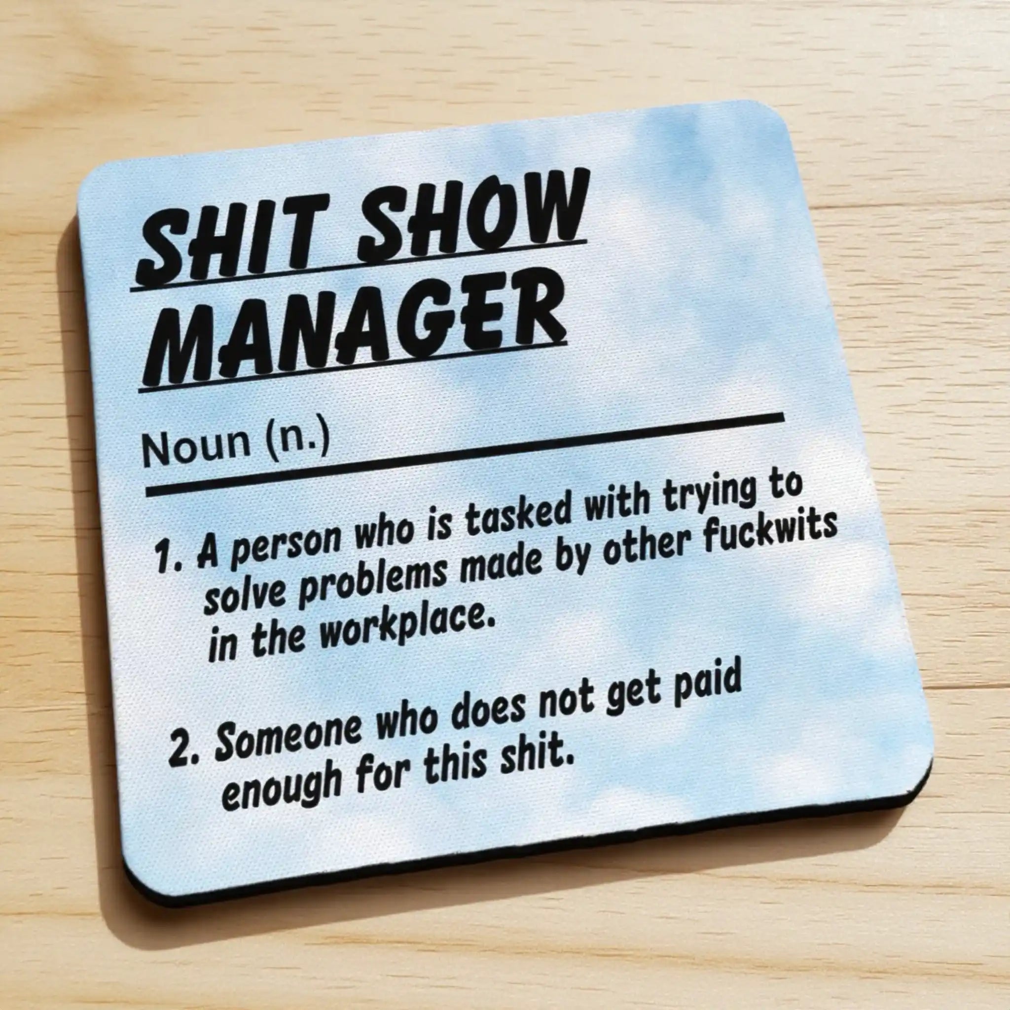 Side view of a Shit Show Manager neoprene coaster displaying the humorous definition, by Laser Design Creations.