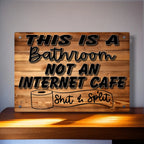 Funny bathroom sign with the quote 'This is a bathroom not an internet cafe, Shit & Split' on a wood-effect background from Laser Design Creations