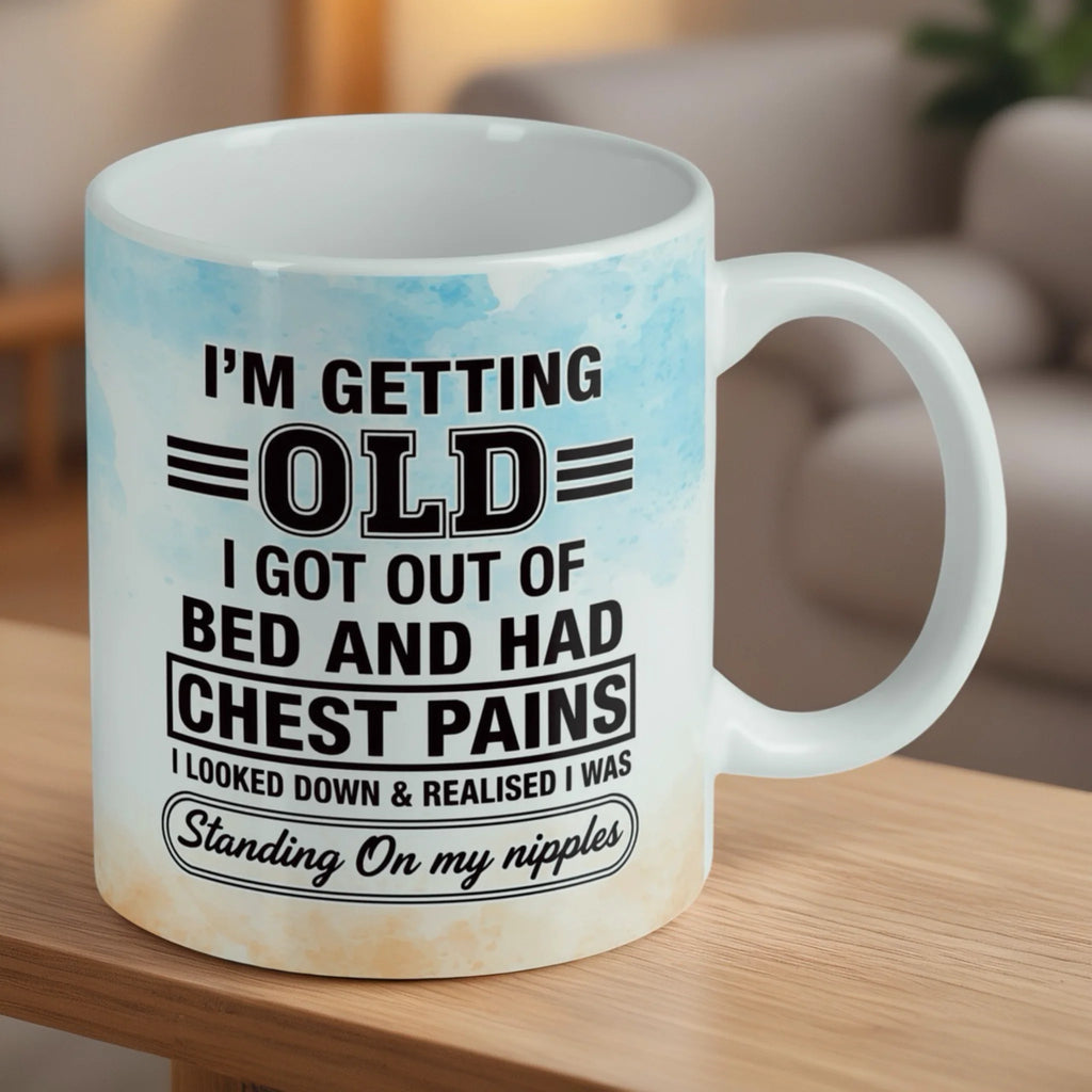 Reverse side of Standing On My Nipples ceramic mug, showcasing the funny aging chest pains joke and colourful watercolour elements by Laser Design Creations.