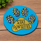 Side view of Stay Pawsitive Blue Paw Print neoprene coasters, showcasing a playful blue paw print theme and a bright, whimsical background by Laser Design Creations.