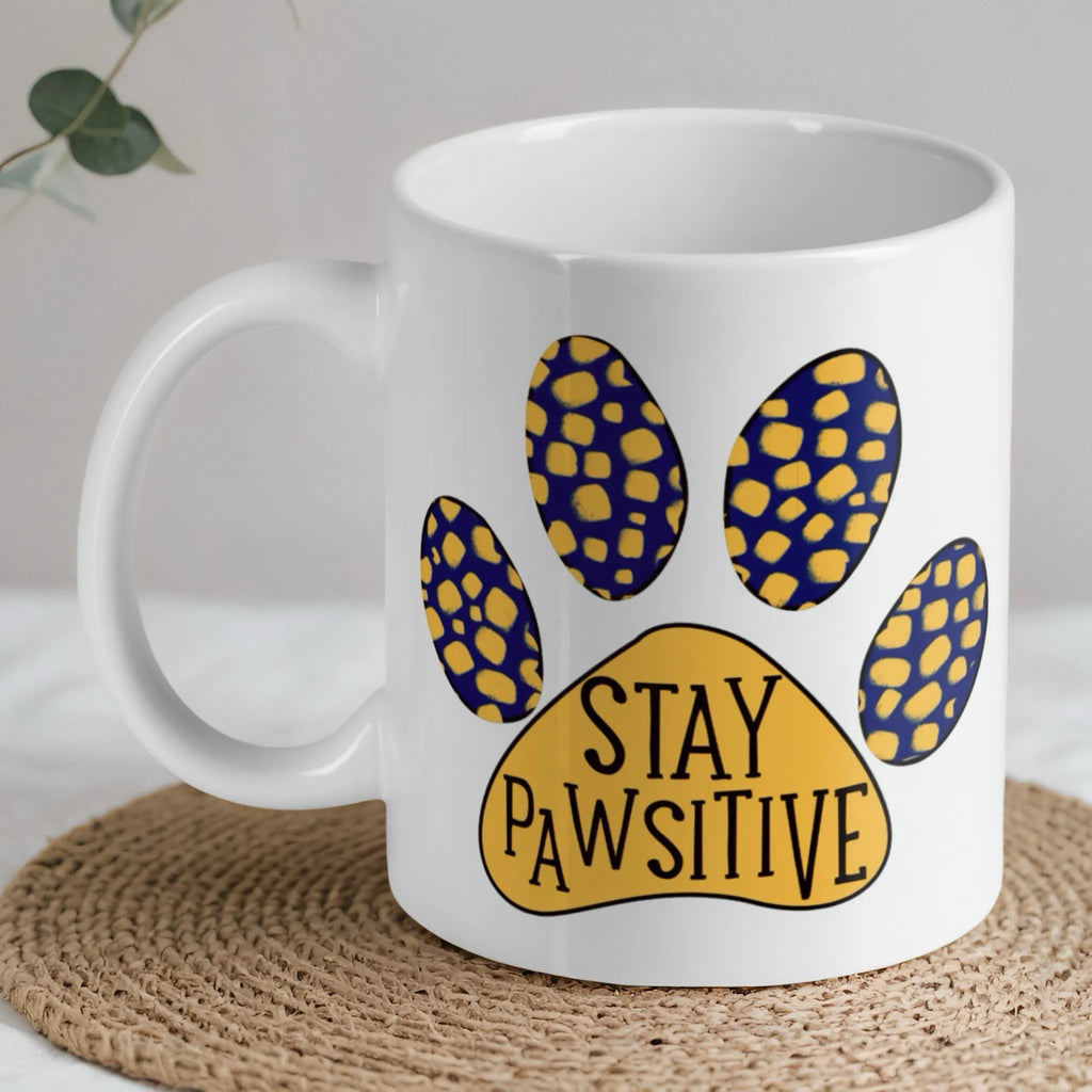 Stay Pawsitive Quote ceramic mug by Laser Design Creations, featuring the playful pun 'Stay Pawsitive' with a colourful paw print.