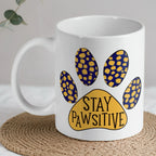 Stay Pawsitive Quote ceramic mug by Laser Design Creations, featuring the playful pun 'Stay Pawsitive' with a colourful paw print.