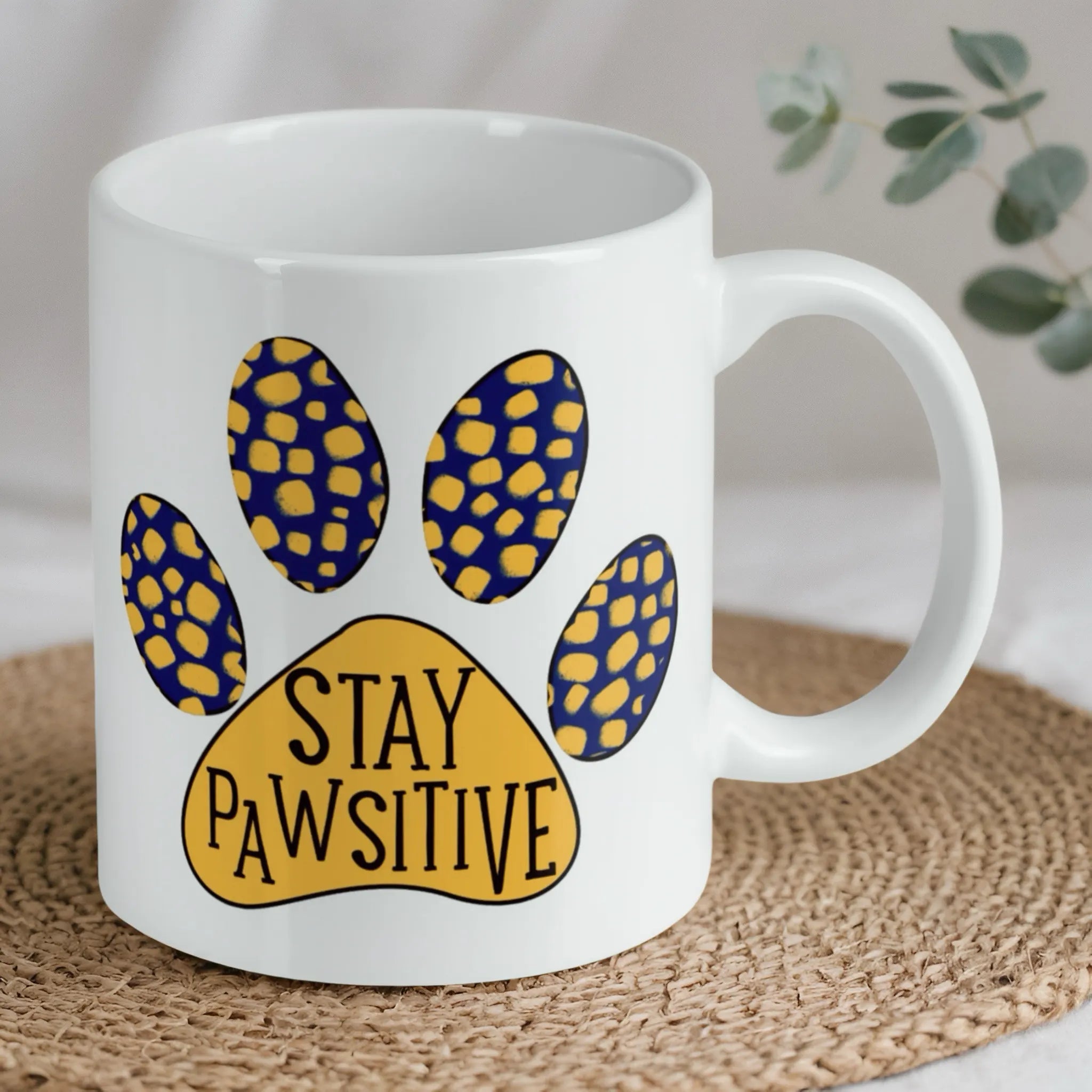 Reverse side of Stay Pawsitive Quote ceramic mug, showcasing the playful pun 'Stay Pawsitive' with a colourful paw print by Laser Design Creations.