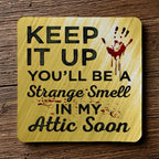 Top view of a set of four 'Strange Smell In My Attic' neoprene coasters with a dark humour quote and bloody handprint, by Laser Design Creations.