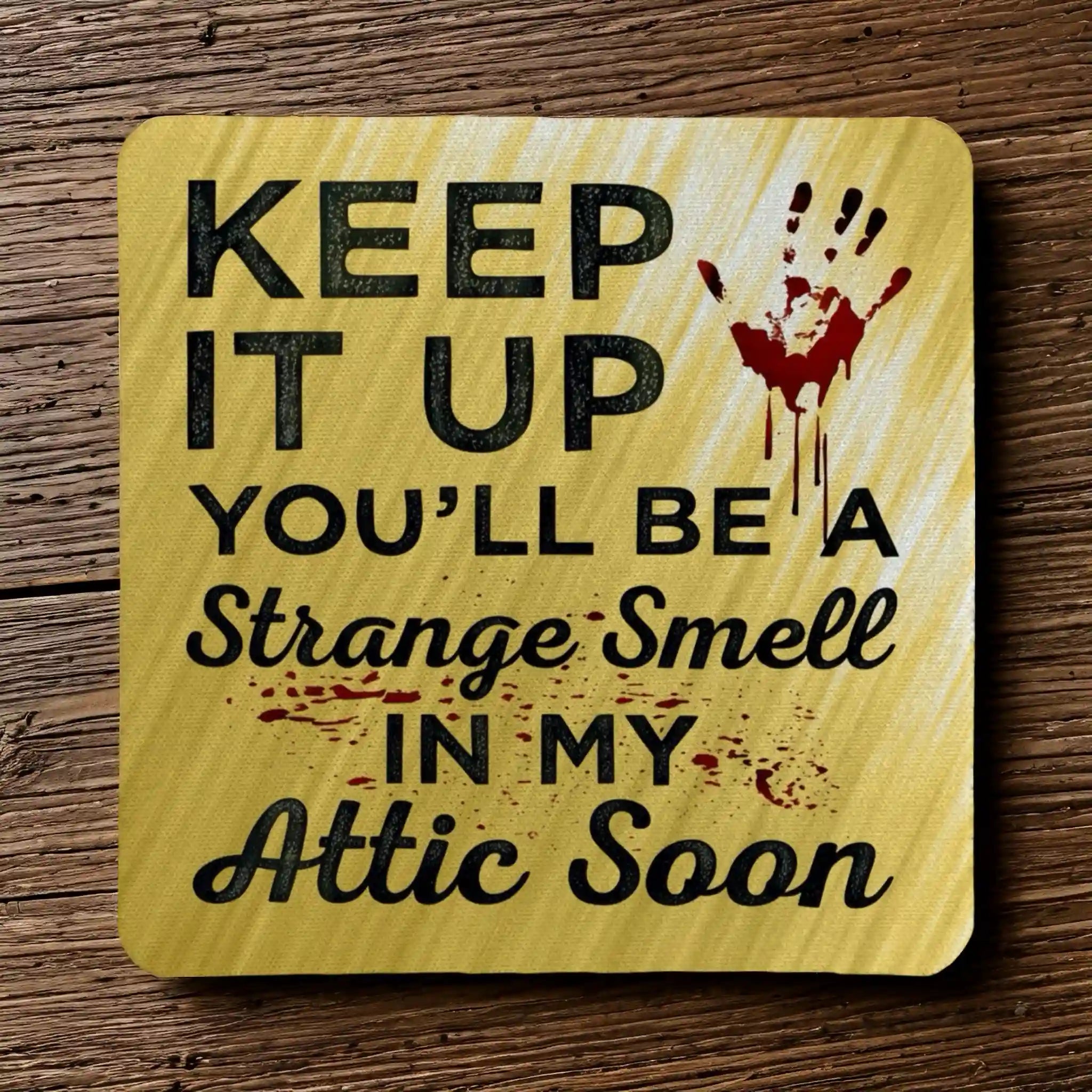 Top view of a set of four 'Strange Smell In My Attic' neoprene coasters with a dark humour quote and bloody handprint, by Laser Design Creations.
