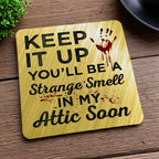 Side view of a set of four 'Strange Smell In My Attic' neoprene coasters with a sarcastic theme, by Laser Design Creations.